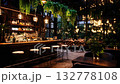 A trendy and stylish indoor bar showcasing vibrant plants, warm lighting, and a welcoming and cozy atmosphere 132778108