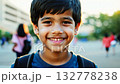 Close up view of a Caucasian pupil boy with backpack standing next the school. Smiling Caucasian boy with backpack stands proudly near his school, ready for a great day. 132778238