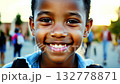 Close up view of an African American pupil boy with backpack standing next the school. Smiling boy with backpack confidently looks at camera near his school. 132778871