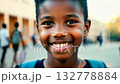 Close up view of an African American pupil boy with backpack standing next the school. Cheerful schoolboy stands proudly near school, backpack ready for the day. 132778884