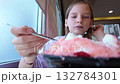 Preteen Girl Eating Huge Signature Ice Cream Dessert at Cafe 132784301