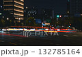 A long exposure timelapse shows car headlights and taillights creating streaks of light across a Hangzhou street at night. 132785164