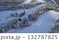 Aerial view of snowy ski slope with people skiing and chairlifts in winter mountain resort. Perfect for themes of travel, tourism, winter sports, lifestyle, and holiday adventure. 132787825