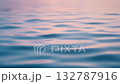 Gentle ocean surface moving in slow motion, soft sunlight reflections, relaxing pastel tones, minimal ripples, peaceful atmosphere, ideal for meditation or spa themes, loopable 132787916