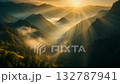 Majestic sunrise over photorealistic mountains, soft golden light rays spreading across misty peaks, atmospheric perspective, cinematic look, natural color grading 132787941