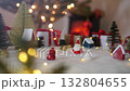 Santa claus doll with christmas decorations with blurred lights on christmas tree 132804655