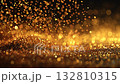 Golden sparkles create a shimmering effect on a dark background during a festive celebration or event 132810315
