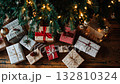 Presents wrapped in festive paper arranged under a decorated Christmas tree in a cozy room filled with holiday cheer 132810324