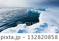 Icebergs tower dramatically above a pristine, icy expanse, reflecting subtle hues while the sky casts a soft light during the tranquil day 132820858