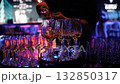 The waiter pours white wine into the glass. Wine glasses on nice back light Sommelier waiter pours white wine into glasses at indoor party. A waiter pours white wine into glasses in a restaurant. 132850317