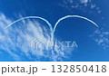 Outdoor aviation scene captures moment when aircraft leave symmetrical smoky pattern resembling heart, rich sky tones and faint clouds create dynamic background for creative air display. 132850418