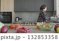 Woman Washing Cutting Board After Preparing Fresh Vegetables In Modern Kitchen 132853358