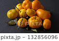 Vibrant fresh orange mandarins piled high on table for juicing or snacking. 132856096