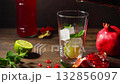 Pouring fresh homemade pomegranate juice with a fruit side dish. 132856097