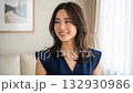 Portrait of a woman smiling toothily in a bright living room 132930986