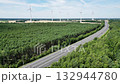 Wind power and green energy, wind turbines produce energy in the forest near the road, power extraction, alternative energy sources, wind force. 132944780