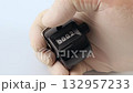 Close-up of a hand wearing rubber gloves pressing a black manual counter from zero to ten on a white background, representing accuracy, measurement, counting process, and meticulous work safety. 132957233