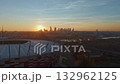 Aerial view of Warsaw at sunset with National Stadium, Swietokrzyski Bridge and city skyline glowing in golden light. 132962125
