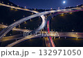 Intricate highway interchange at night, with multiple elevated roads creating a complex network as vehicle lights leave long streaks, symbolizing modern transportation and urban connectivity 132971050