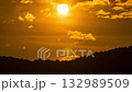Dramatic sunset time-lapse showing the sun rising above the horizon with colorful sky and gentle motion. 132989509