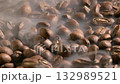 Slow motion of roasted coffee beans falling with smoke. Organic coffee seeds. 132989521