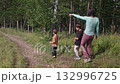 Mother and children exploring nature trail in lush forest 132996725