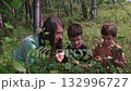 Mother teaching botany to children in forest 132996727