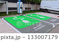 Sofia, Bulgaria - 11.10.2025. Modern electric vehicle charging station with two green-marked parking spaces for EVs. Sustainable transportation and clean energy infrastructure in an urban environment. 133007179