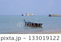 A Fishing Boat On The Beach And A Ferry In The Middle Of The Sea 133019122
