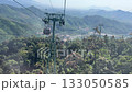 Cable cars in Da Nang Vietnam passing above mountains and cityscape leading to Ba Na Hills scenic aerial view 133050585