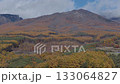 Beautiful autumn foliage at the foot of Mount Asama, Mount Kurobanza, Mount Kengamine, and snow-capped Mount Maekake in Miyota Town, Nagano Prefecture (aerial photo taken by drone) 133064827