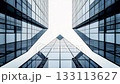 Abstract, symmetrical low-angle view of modern skyscrapers. Sleek glass lines create a powerful image of corporate success, finance, and future growth. 133113627
