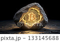 Conceptual 3D image of cryptocurrency mining. A physical, glowing gold Bitcoin is discovered or mined from a dark rock, symbolizing value, blockchain technology, and digital assets. 133145688
