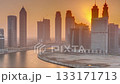 Sunset cityscape of skyscrapers in Dubai Business Bay with water canal aerial timelapse 133171713