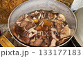 Boiling honey mushrooms in cooking pot 133177183