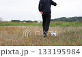 Rear view of a soccer player practicing dribbling 133195984
