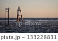 Lighthouse and ship in shallow waters 133228831
