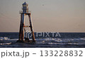 Lighthouse and seabirds in shallow waters 133228832
