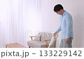 A young man vacuuming happily while talking to his pregnant partner A young man vacuuming happily while talking to his pregnant partner 133229142