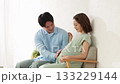 A young couple relaxing on the sofa, pregnant woman A young couple relaxing on the sofa, pregnant woman 133229144