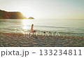 Woman walking along sandy beach at sunrise in Kefalonia Greece 133234811