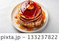 Top view of delicious pancakes with maple syrup on a white plate. 133237822