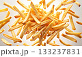 Crispy French fries in midair, scattered against a clean, open background 133237831