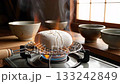 Steam rises from the grilled rice cakes in a Japanese kitchen 133242849