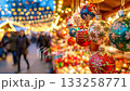 Colorful christmas baubles hanging at a festive market with people and glowing bokeh lights in background. 133258771