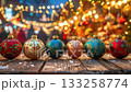 Christmas ornaments sparkling on wooden table with bokeh lights. 133258774