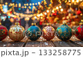 Christmas ornaments sparkling on wooden table with bokeh lights. 133258775