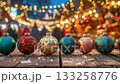Christmas ornaments sparkling on wooden table with bokeh lights. 133258776