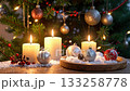 Lit candles and shiny ornaments create a festive Christmas scene. 133258778