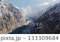 Aerial view of a majestic Pakistani glacier nestled between towering snow-covered mountains 133309684